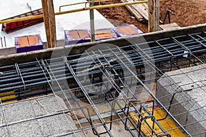 Construction site with steel formworks and reinforcing bars for