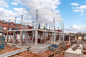 Construction site with steel formworks and reinforcing bars for pillars ready for concrete