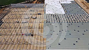 Construction site with steel frame structure of warehouse building, aerial view