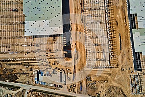 Construction site with steel frame structure of warehouse building, aerial view