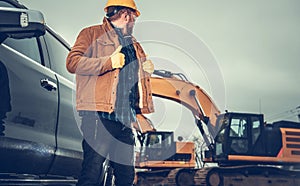 Construction Site Supervisor Checking on Heavy Ground Equipment