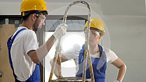 Construction site team or architect and builder with helmets having discussion at apartment house