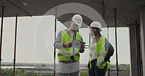 Construction site Team or architect and builder or worker with helmets discuss on a scaffold construction plan or