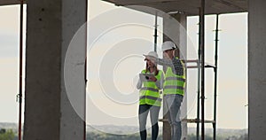 Construction site Team or architect and builder or worker with helmets discuss on a scaffold construction plan or