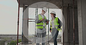 Construction site Team or architect and builder or worker with helmets discuss on a scaffold construction plan or