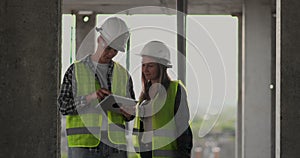 Construction site Team or architect and builder or worker with helmets discuss on a scaffold construction plan or