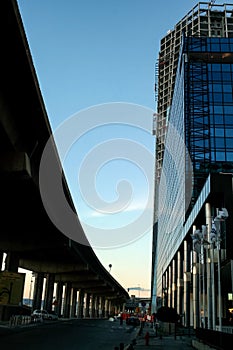 Construction site of the Tour CMA CGM tower next to a motorway viaduct.