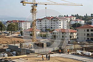 Construction site with tower crane and building frames