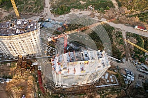 Construction site with tower crane on formworks. Crane on construction the building and multi-storey residential homes. Housing