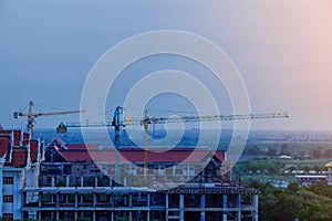 Construction site Unfinished cement building, Industrial construction cranes and building country local Thailand