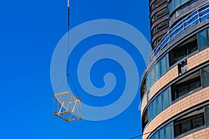 Construction site urban development background with crane lifting cube structure