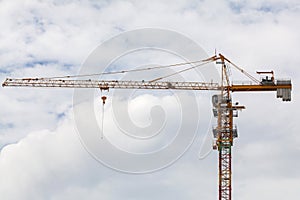 Construction site view of crane, lift, metal beam, brick, metal ladder and concrete