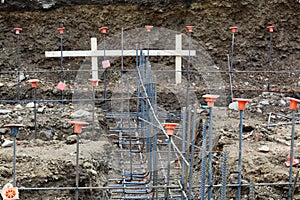 Construction site view looking down footings with gridwork of rebar