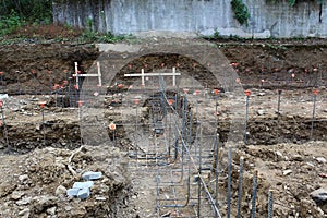 Construction site view over unpoured footings with steel rebar gridwork