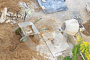 Construction site. View from top. Wheelbarrow and concrete mixer.