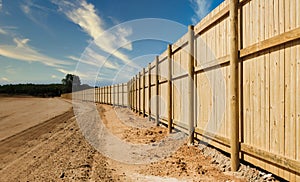 Construction site with wooden fence and new land blocks