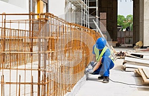 A construction site worker drills with a drill stock image