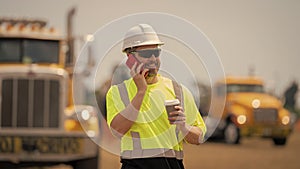 construction site worker hold coffee. mature architect in construction area. caucasian construction manager. Builder in