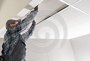 Construction Site Worker Installing Suspended Ceiling
