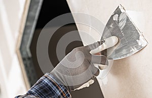 Construction Site Worker Patching a Wall