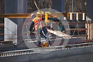 Construction site worker with safety harness hook