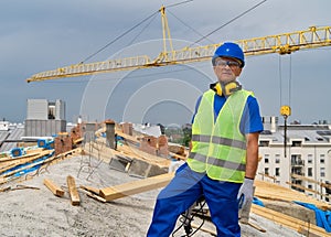 A construction site worker stands at the roof.Construction site worker.