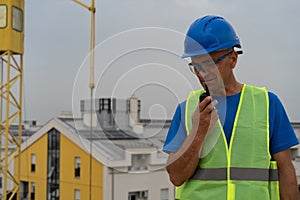 A construction site worker talking on a walkie-talkie stock image