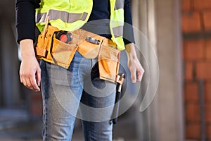 Construction site worker wearing belt with tools
