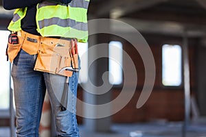 Construction site worker wearing belt with tools