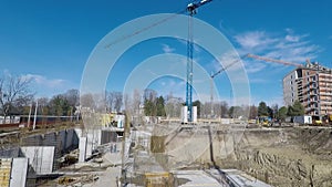 Construction site with workers cranes and excavator