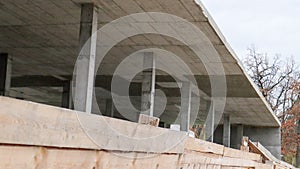 Construction site with workers. Modern buildings under construction behind a wooden fence. Construction works. Monolithic one-