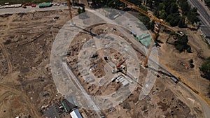 Construction of a sports arena. There is a football stadium nearby. The camera is down. Aerial photography