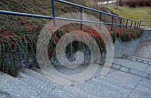 construction of a steep staircase by the stone wall car park with high