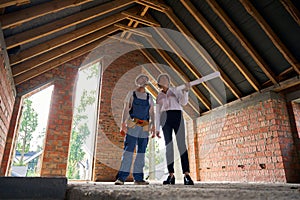 Construction superintendent and builder conducting inspection of house