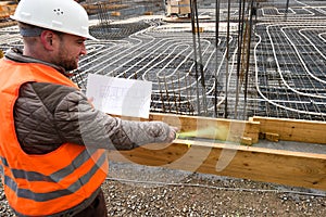 Construction supervisor with plan marking the site