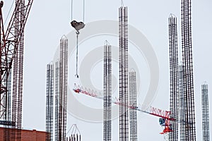 Construction, tall cranes, metal lattice and concrete reinforcement.