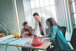 Construction Team with engineer and architect is smiling and laughing in meeting table