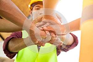 [Construction Teamwork] Team of engineer and architects working join hands to build successful projects. Teamwork concept