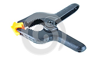 Construction tool black plastic clothespin on a white background