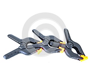 Construction tool black plastic clothespin on a white background