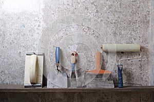 Construction tools on concrete background. Copy space for text. Set of assorted plaster trowel and spatula