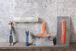 Construction tools on concrete background. Copy space for text. Set of assorted plaster trowel and spatula