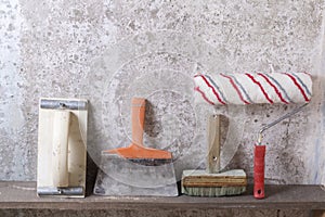 Construction tools on concrete background. Copy space for text. Set of assorted plaster trowel and spatula