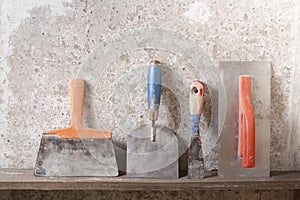 Construction tools on concrete background. Copy space for text. Set of assorted plaster trowel and spatula