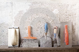 Construction tools on concrete background. Copy space for text. Set of assorted plaster trowel and spatula