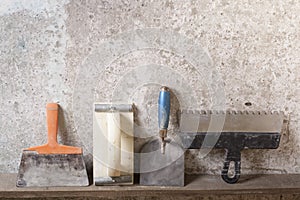 Construction tools on concrete background. Copy space for text. Set of assorted plaster trowel and spatula