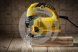 Construction tools electric corded jigsaw on wooden background