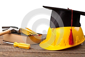 Construction tools and a graduate hat