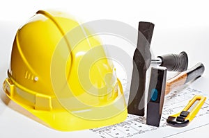 Construction tools, hardhat and blueprint