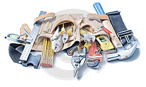 Construction tools in leather toolbelt isolated on white